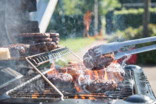 grilling hamburgers over flame